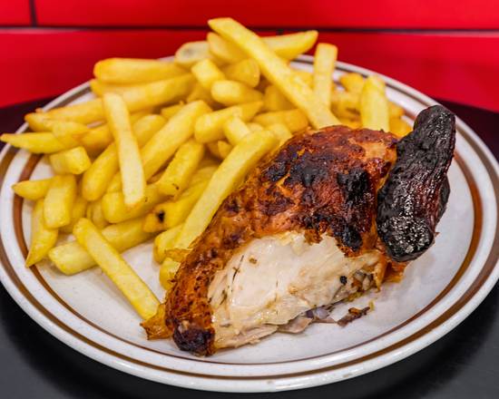 A quarter charcoal chicken, skin charred and crisp, with a pile of hot chips