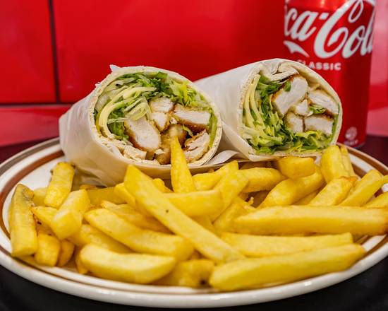 A charcoal chicken wrap cut in half to show the chicken and salad, served with chips